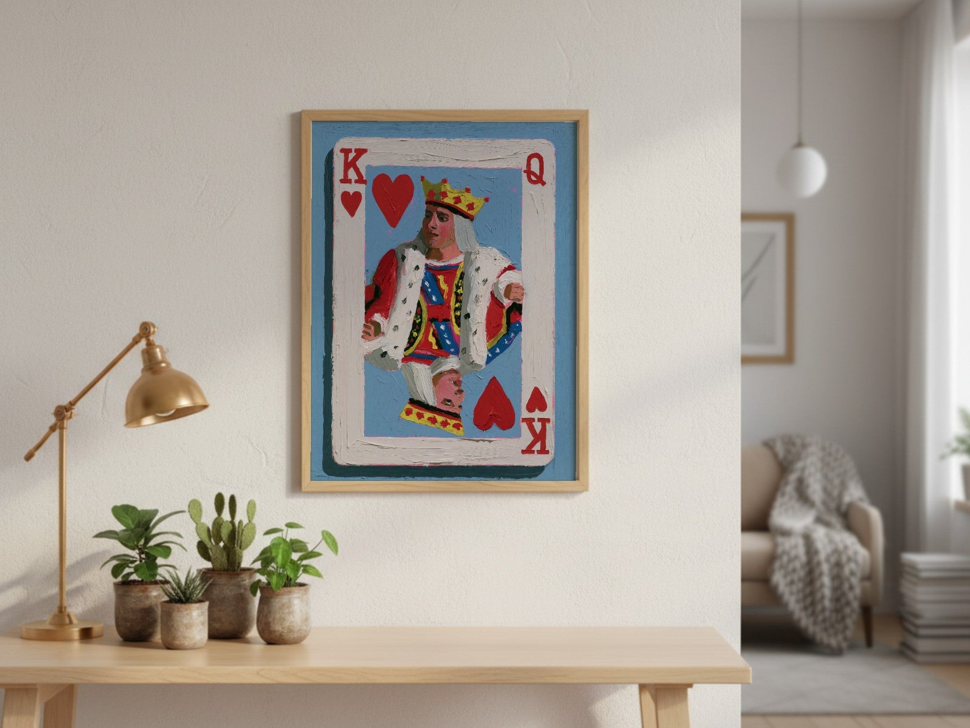 King of Hearts framed art above a console table